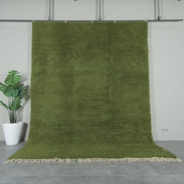 Authentic handmade Moroccan olive green Beni Ourain rug crafted with 100% natural lamb’s wool by skilled Berber women artisans. This lush olive green wool rug adds earthy elegance and cultural warmth to modern and rustic interiors. Perfect for living rooms, bedrooms, and wall décor.