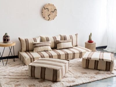 Set of Moroccan sofa pillows arranged on cream and brown floor cushion