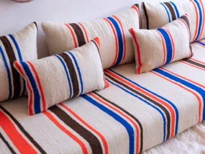 Accent pillows in cream wool with blue and orange Berber stripes