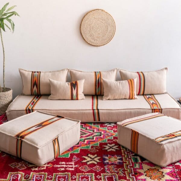 Handmade Moroccan floor couch set in cream wool with orange and black embroidered patterns, unstuffed cushions with zippered covers